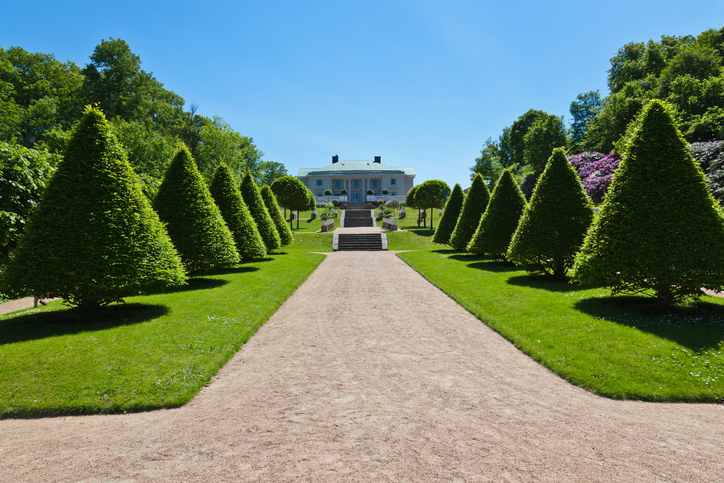 Gunnebo Castle garden in Mondal, Sweden. with trimmed trees along the garden path