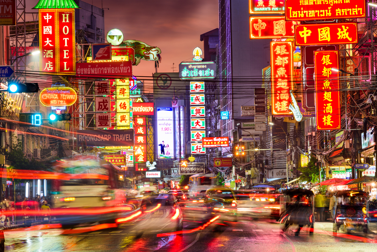 Bangkok, Thailand - September 27, 2015: Heavy traffic on Yaowarat Road passes below lit signs in the Chinatown district at dusk. Yaowarat has been the main center of Chinese culture in Bangkok for over 200 years.