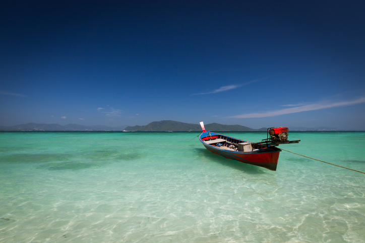 Boat on the clear water at Ko Racha Yai Island, Thailand.