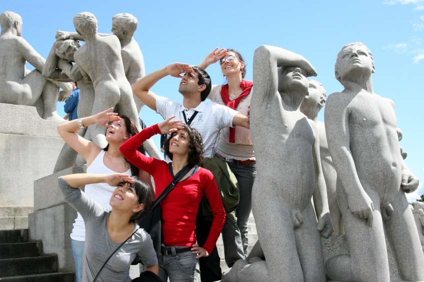 OSLO, NORWAY- JUNE 23: A group of unidentified tourists pose for a photo imitating the statues in Vigeland park in Oslo, Norway on June 23, 2006. The park is one of the most visited attractions in Norway with more than 1 million visitors a year.
