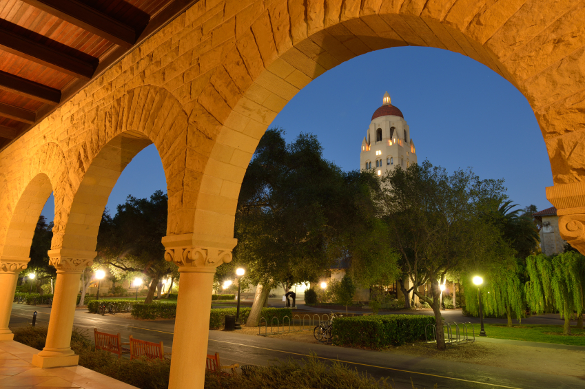 Stanford, USA - September 22, 2014. View of Hoover Tower through arched door in the campus of Stanford University at night. Stanford University is a world famous private research and teaching university located in Stanford, California. It was founded in 1885 in a suburban setting.