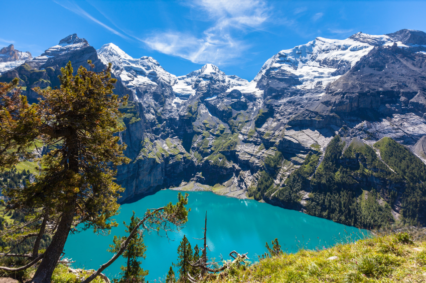 The panorama in summer view over the Oeschinensee (Oeschinen lake) and the alps on the other side near Kandersteg on Bernese Oberland in Switzerland.