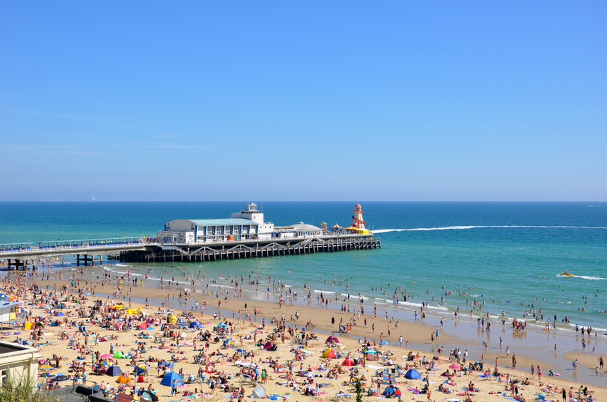 Detail of Bournemouth Pier and crowded beach.