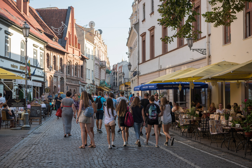 Vilnius, Lithuania - August 6, 2015: Pedestrians and people at cafes enjoy a summer day on Pilies Street in the old town of Vilnius, Lithuania
