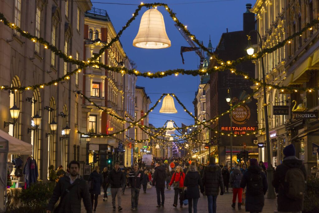 Karl Johans gate med folk i gatene og julelys.