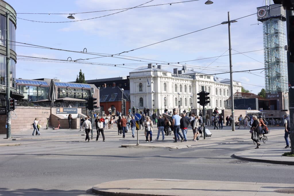 Oslo by med folk i gatene og Oslo S i bakgrunnen. Hva kan man gjøre i Oslo?