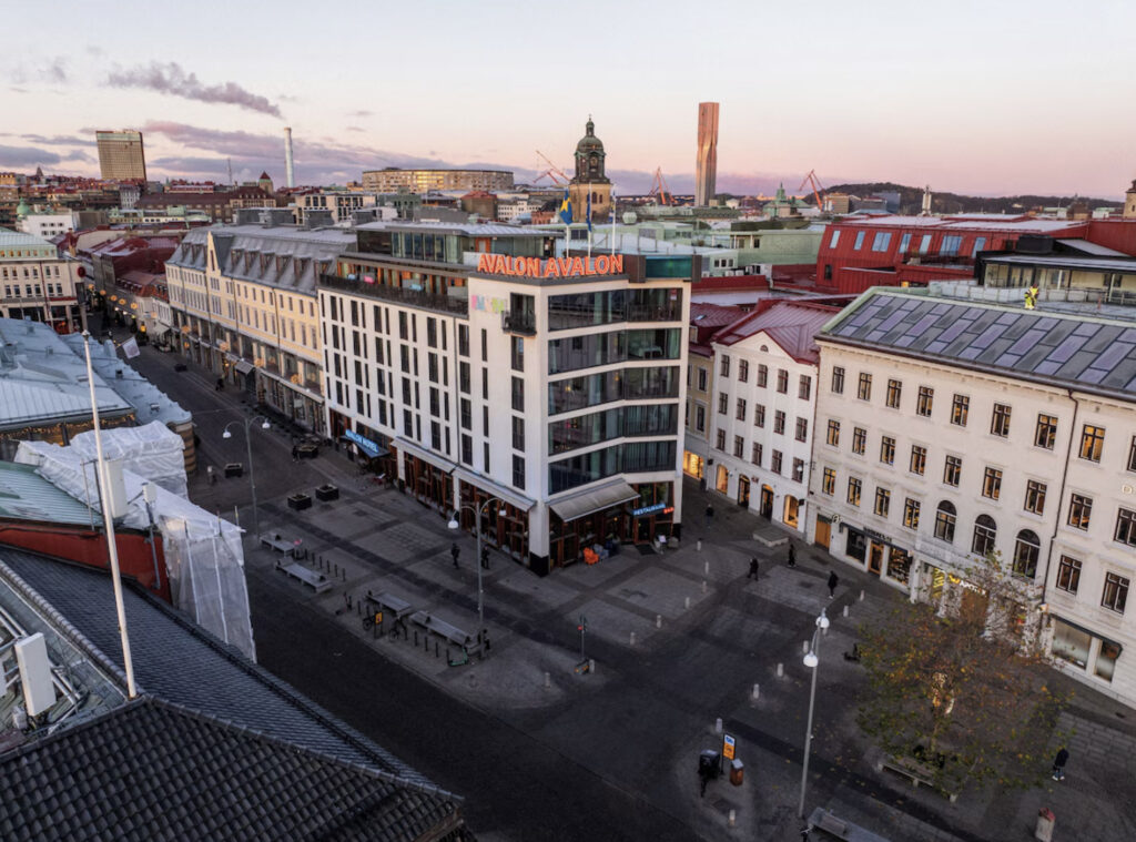 Hotel Avalon i Sverige med fasade, gater og solnedgang.