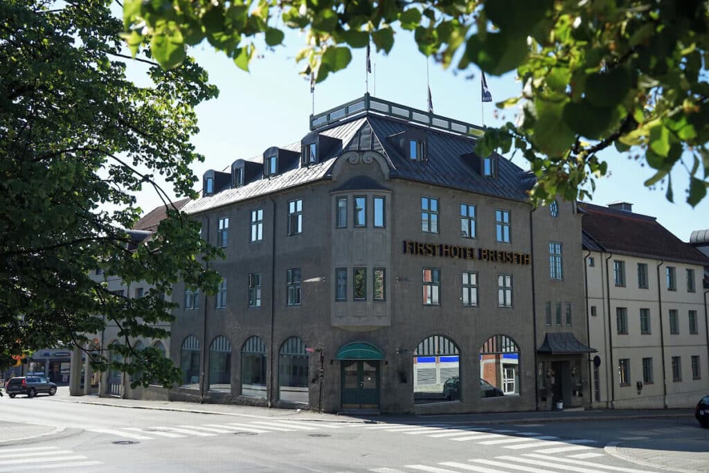 Hotellfasade med tom gate.